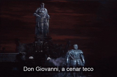 don giovanni a cenar teco is written on a screen in front of a statue