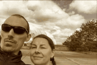 a man and a woman wearing sunglasses are posing for a photo