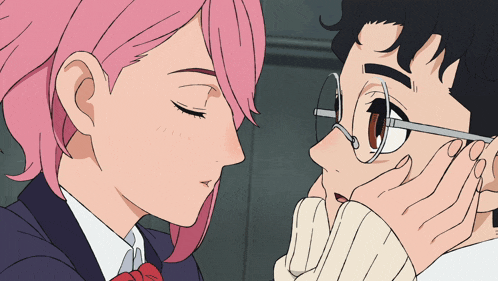 a man and a woman with pink hair are kissing