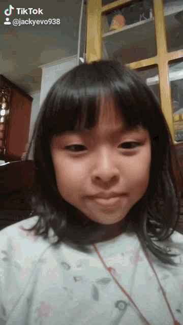 a little girl 's face is shown in a tiktok video taken by jackyevo938