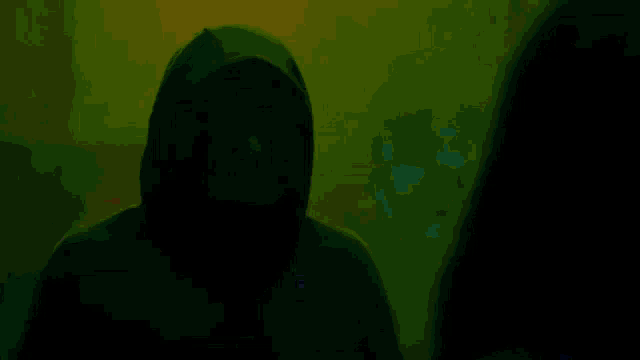 a man and a woman are standing next to each other in a dark room .