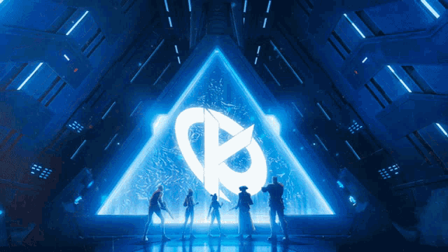 a group of people are standing in front of a blue triangle with a circle in the middle
