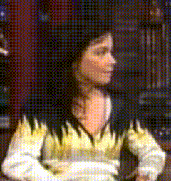a woman wearing a sweater with flames on it