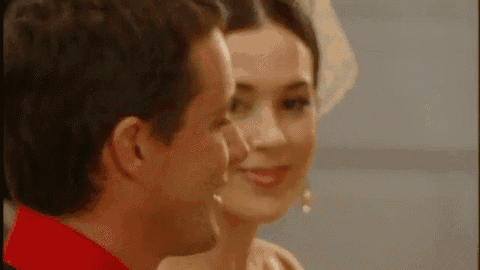a man and a woman are looking into each other 's eyes .