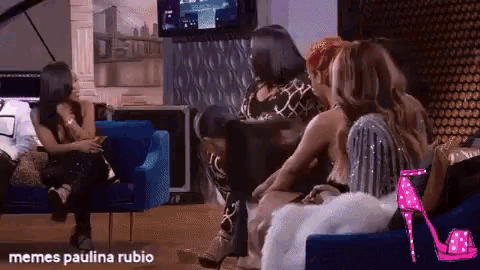 a group of women are sitting on a couch with the words memes paulina rubio below them