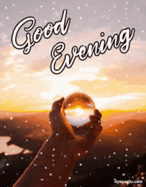 a person holding a glass ball with the words good evening written above it
