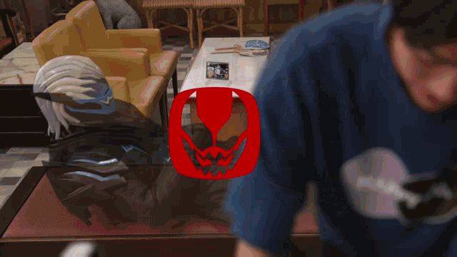 a man in a blue shirt is standing in front of a red icon