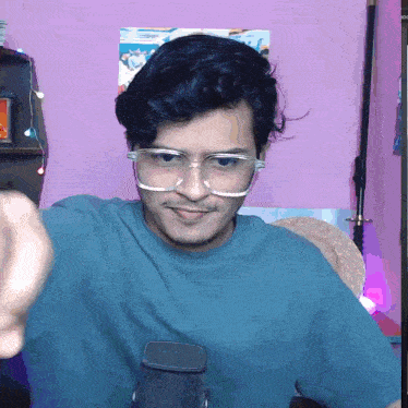a young man wearing glasses and a blue shirt