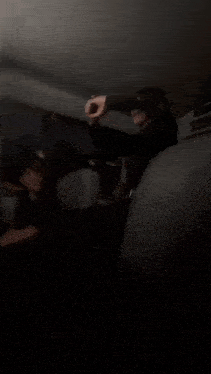 a blurry picture of a man in a car with a red light on the ceiling .