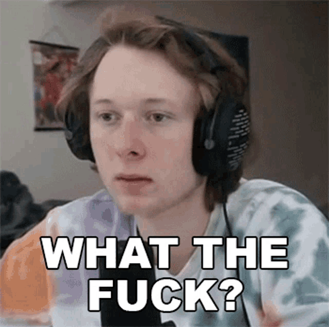 a young man wearing headphones and a tie dye shirt is asking what the fuck .