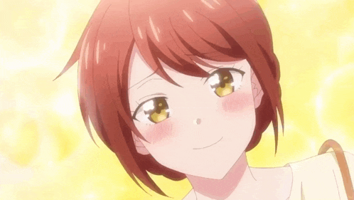 a close up of a girl with red hair and yellow eyes .
