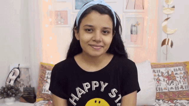 a young girl wearing a black shirt that says happy stars