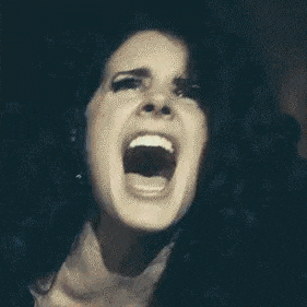 a close up of a woman with her mouth open .