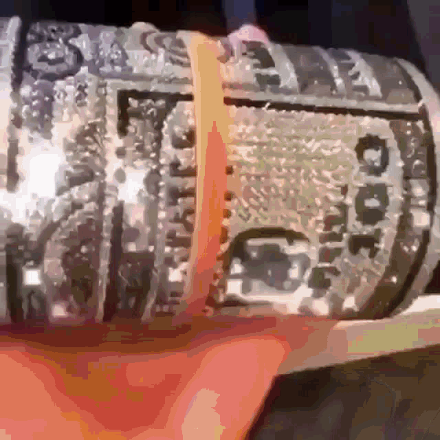 a close up of a person holding a dollar bill that says ' gucci ' on it