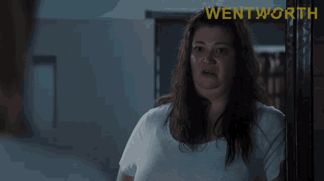 a woman in a white shirt is smiling and says welcome