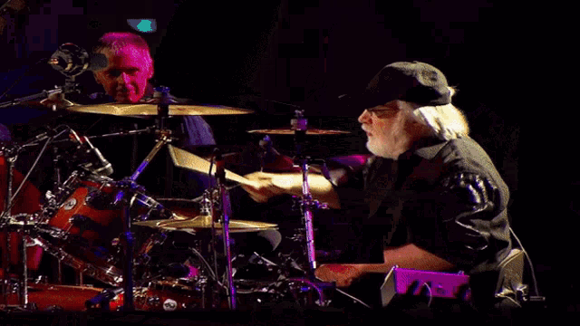 a man is playing drums with a cymbal that says paiste