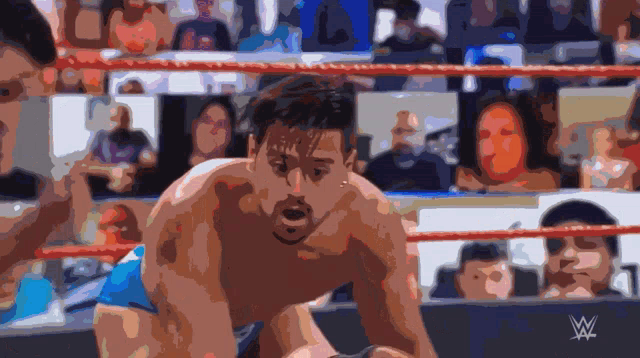 a man in a wrestling ring with the w logo on the bottom