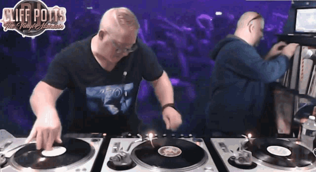 two men are playing records in front of a sign that says " cliff potts "