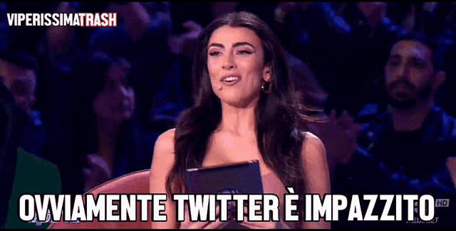 a woman sitting in front of a crowd with the words " ovviamente twitter e impazzito " on the bottom