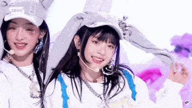 two girls are wearing bunny hats and smiling in front of a screen that says zoom ..