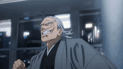 a man with gray hair and a gray shirt with the letter c on it