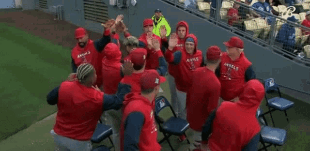 a group of angels baseball players giving each other high fives
