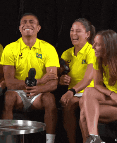 a group of people wearing yellow shirts with the word club on them are laughing