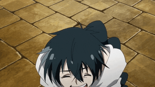 a black haired anime character is laying on a brick floor with his eyes closed