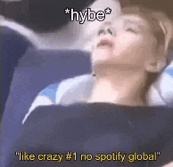 a person is sleeping on a plane with the words `` like crazy # 1 no spotify global '' written on the bottom .