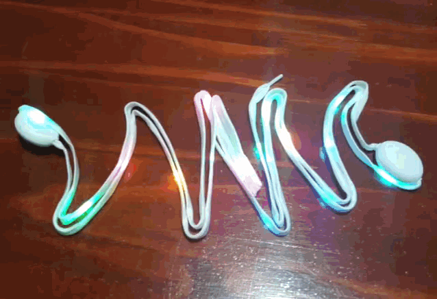 a swirl of lighted wires on a wooden surface that spell out the word swirl