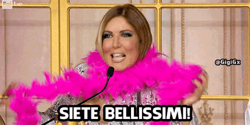 a woman is wearing a pink boa around her neck and says " siete bellissimi "