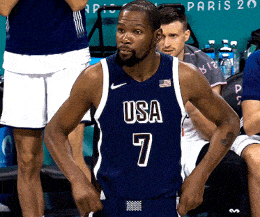 a basketball player wearing a blue usa jersey number 7