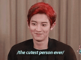 a young man with red hair is smiling and says `` the cutest person ever ''