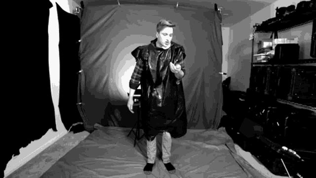 a black and white photo of a man wearing a plastic bag