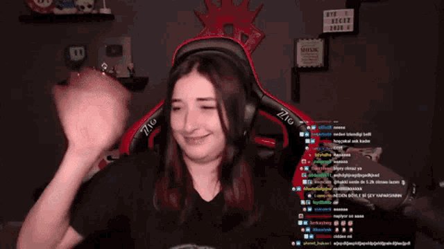 a woman wearing headphones and a gaming chair with the letters zig on the back