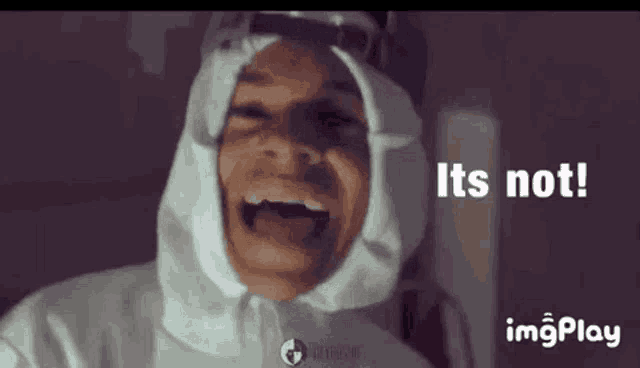 a man in a white suit is laughing and says `` it 's not '' .