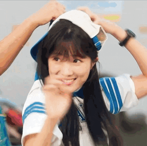 a girl wearing a blue and white uniform with the letter a on it