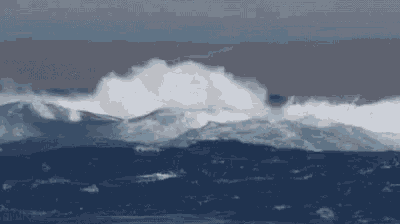 a close up of a large wave in the ocean .