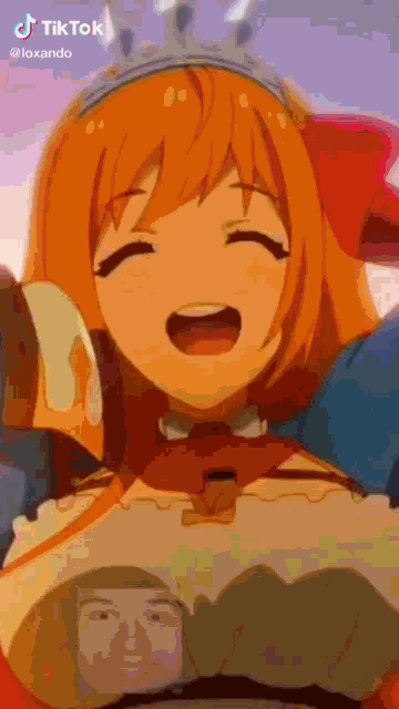 a girl with orange hair is holding a man 's face .
