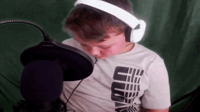 a young boy wearing headphones and a shirt that says ' s ' on it