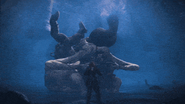 a man holding a sword in front of a giant crab