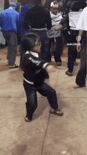 a girl is dancing in a crowd of people .
