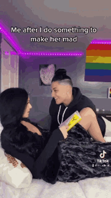 a man and a woman are laying on a bed .