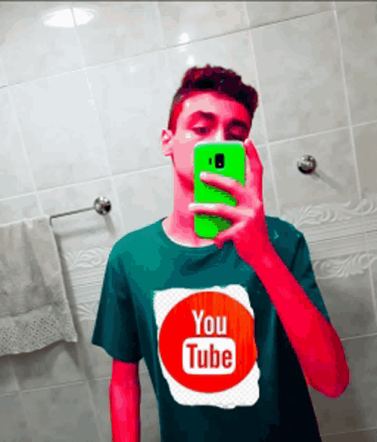 a young man taking a picture of himself with a youtube shirt