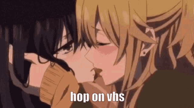 a couple of anime girls are kissing each other with the words `` hop on vhs '' written on the bottom .