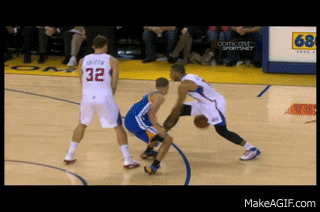 a basketball player with the number 32 on his jersey dribbles the ball