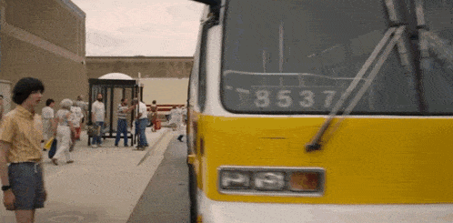 a yellow bus with the number 8537 on the front of it