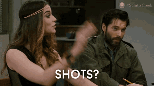 a man and a woman are having a conversation and the woman is saying " shots "