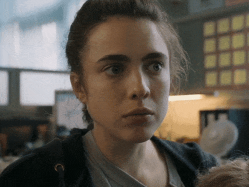 a close up of a woman 's face in a kitchen