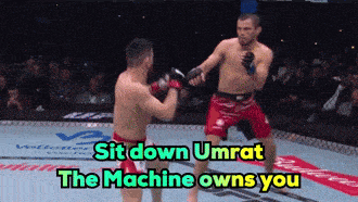 two men are fighting in a boxing ring with the words sit down umrat the machine owns you above them